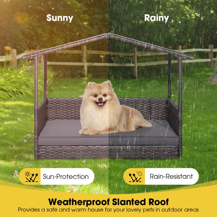Wicker dog house with weatherproof slanted roof, featuring a comfortable cushion for outdoor use in various weather.