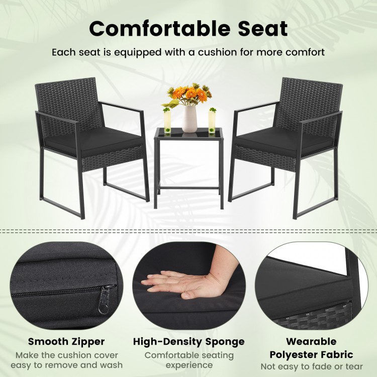 Two black armchairs with cushions and a coffee table, featuring durable PE wicker for outdoor use.