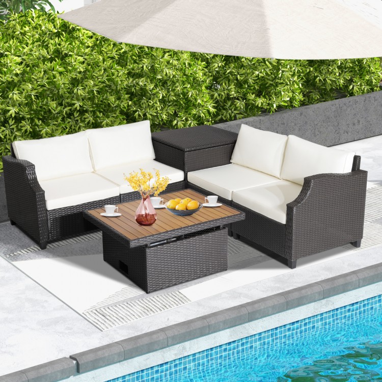 Hand-woven wicker outdoor furniture set with white cushions and acacia wood coffee table, perfect for poolside.
