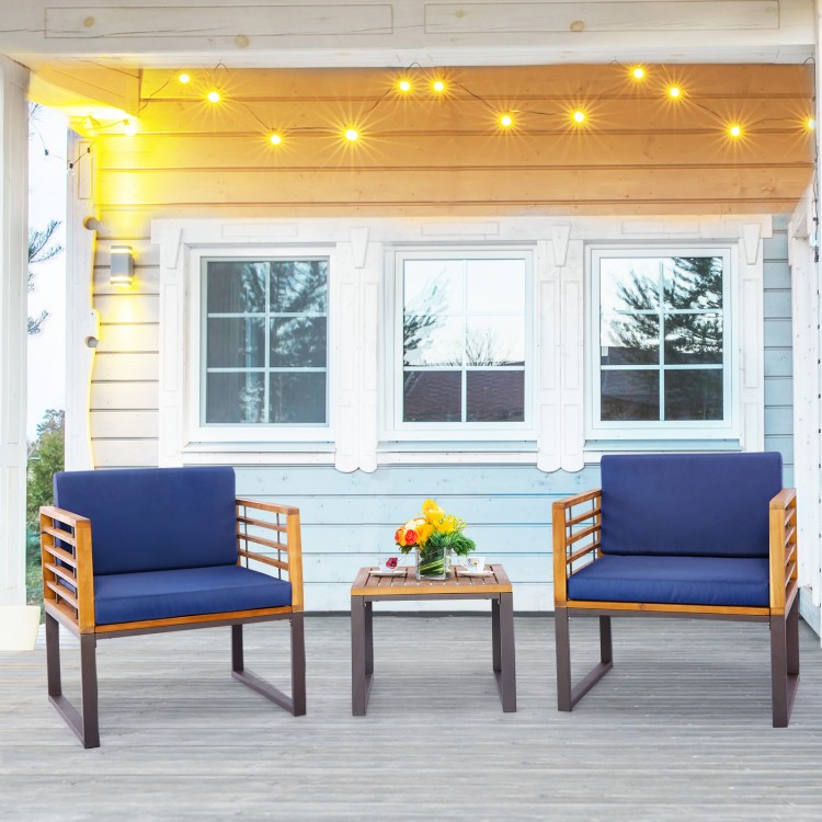 Navy cushioned armchairs and coffee table in a 3-piece patio acacia wood conversation set for outdoor relaxation.