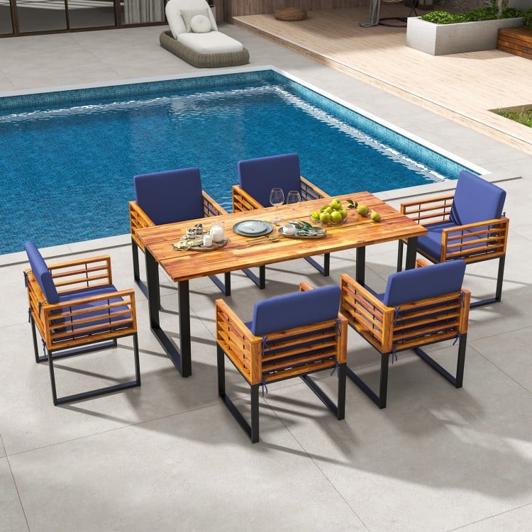 7-piece patio dining set featuring acacia wood table and navy cushioned chairs, perfect for backyard and poolside use.