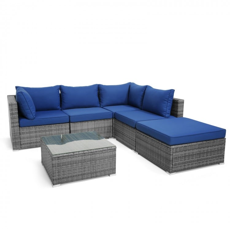 L-shaped 6-piece outdoor rattan sofa set with navy cushions and glass coffee table, perfect for patio or garden use.