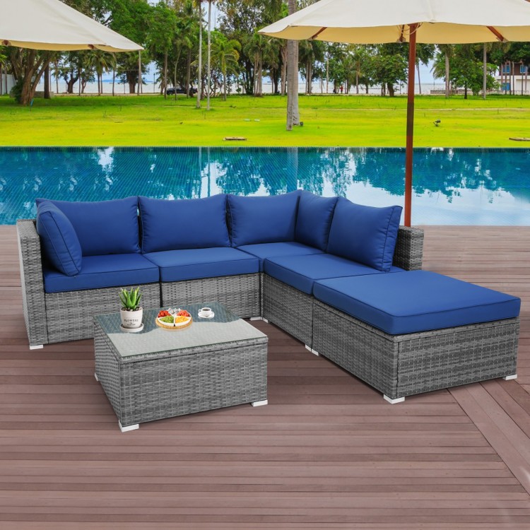 L-shaped 6-piece outdoor rattan sofa set with navy cushions, perfect for patio or poolside relaxation.