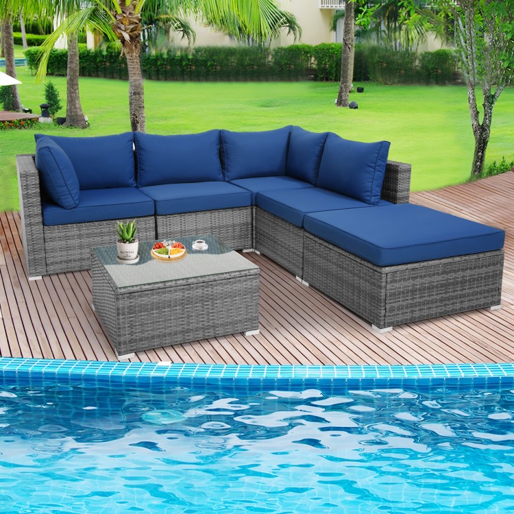 L-shaped outdoor rattan sofa set with navy cushions and a coffee table, perfect for patio or poolside relaxation.