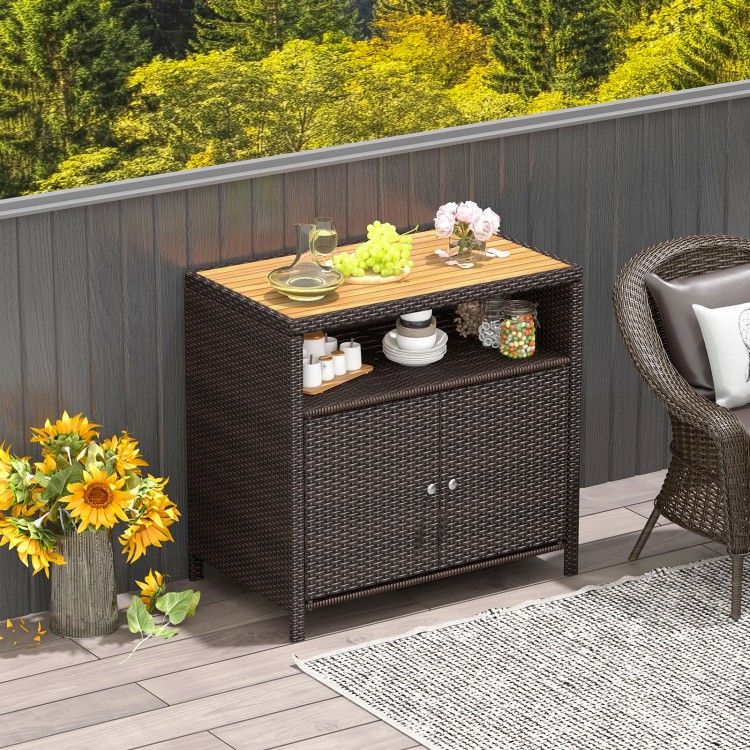 Rattan storage cabinet with a PE rattan surface and acacia wood top, perfect for stylish outdoor storage on patios and.