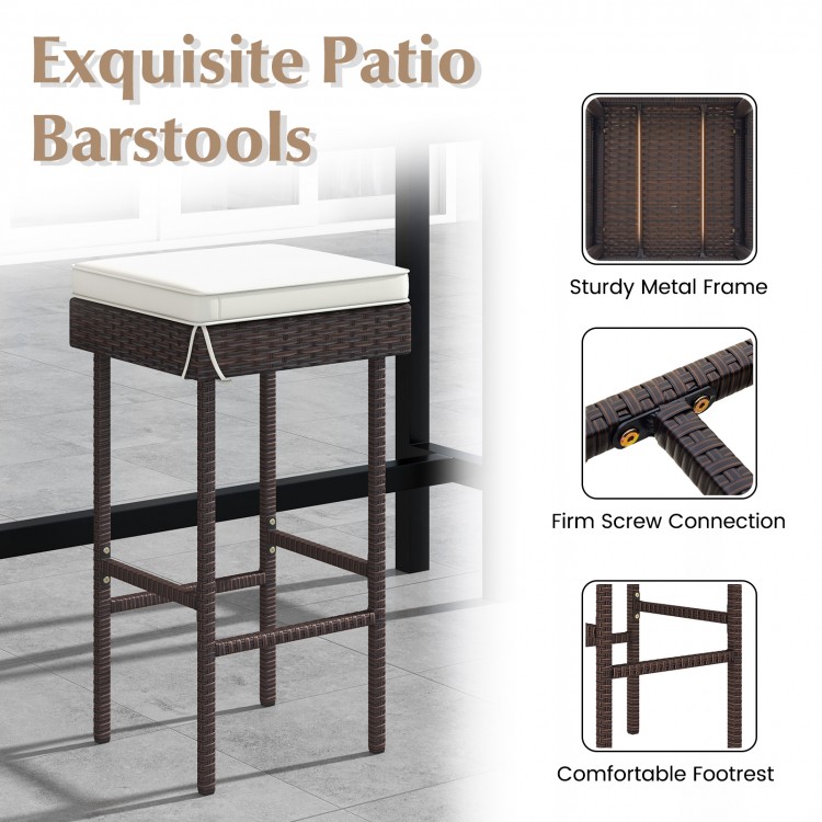Patio rattan barstool with soft cushion and footrest, featuring a sturdy metal frame for backyard or balcony use.