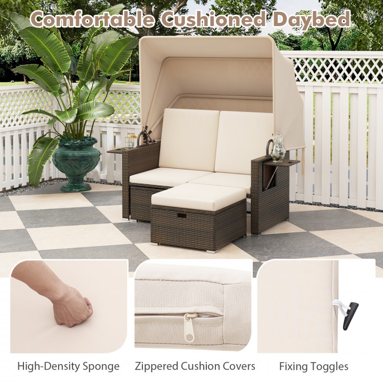 Outdoor patio rattan daybed with retractable canopy, beige cushions, and adjustable backrests for ultimate comfort.