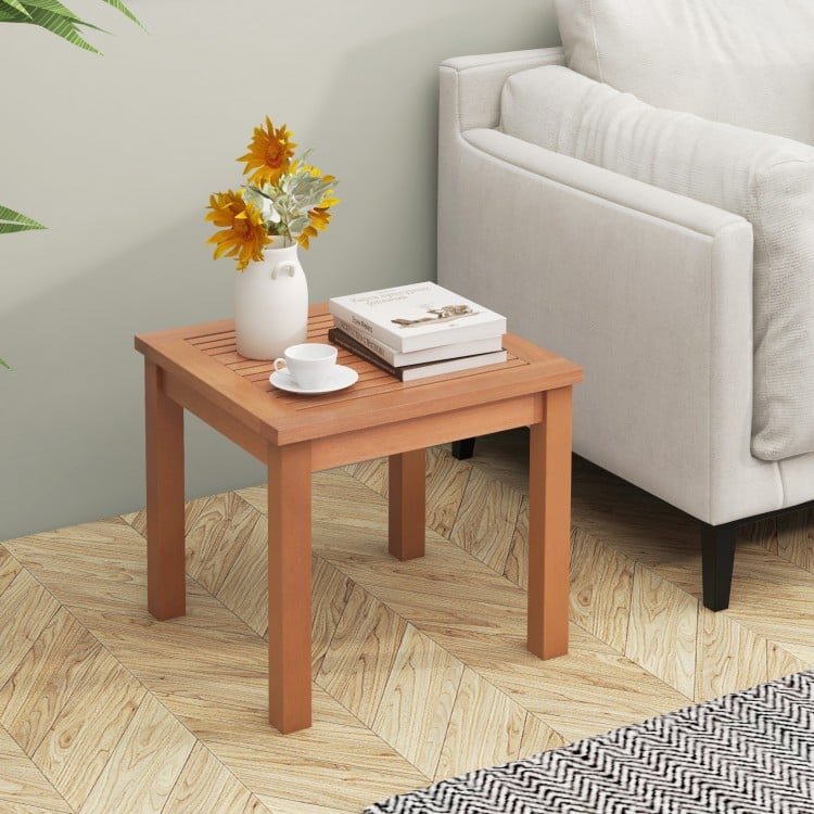 Square end outdoor table made of natural eucalyptus wood with a slatted tabletop, perfect for indoor and outdoor use.