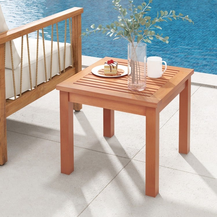 Square end outdoor side table made of natural eucalyptus wood with slatted tabletop, perfect for patio use.