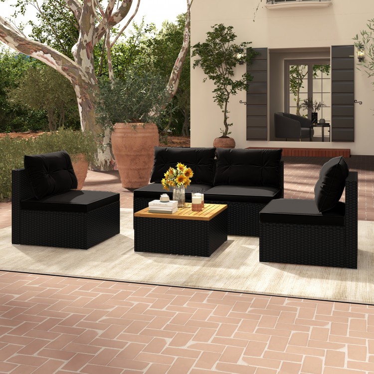 5-piece outdoor furniture set featuring black PE rattan, soft cushions, and a solid tabletop, ideal for backyard.