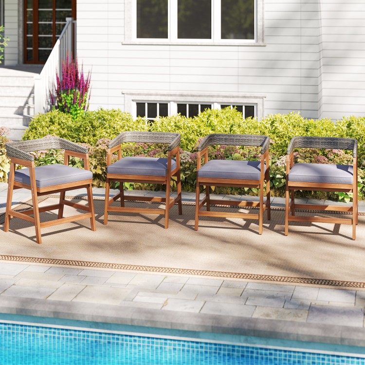 Set of 4 outdoor acacia wood patio wicker dining chairs with gray seat cushions, perfect for poolside relaxation.