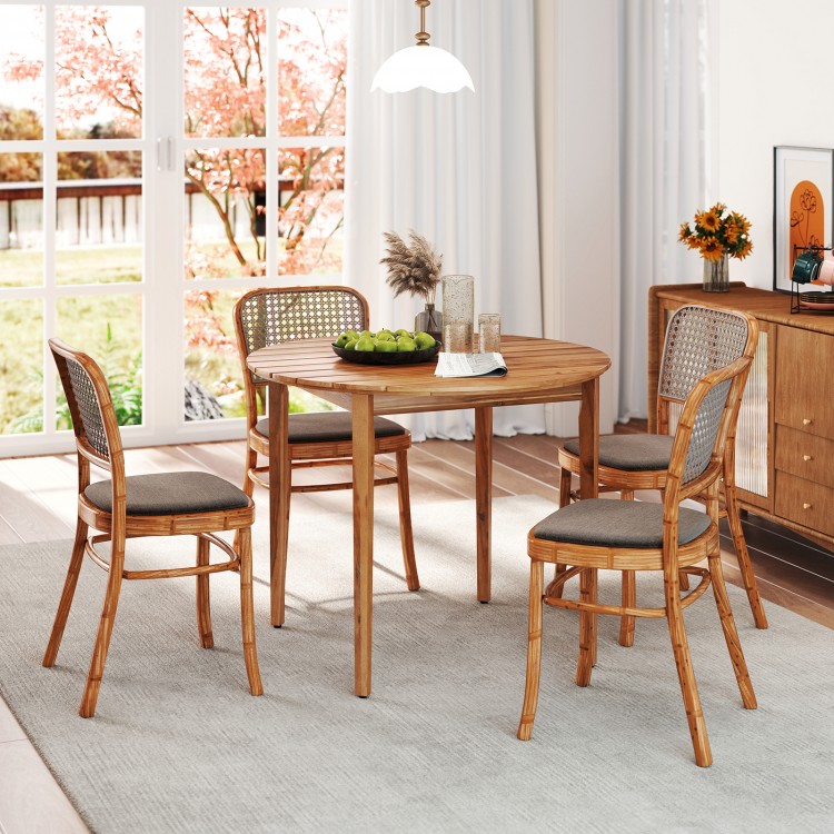 Round 36-inch acacia wood outdoor dining table for 4 with slatted design, placed in a bright indoor setting.
