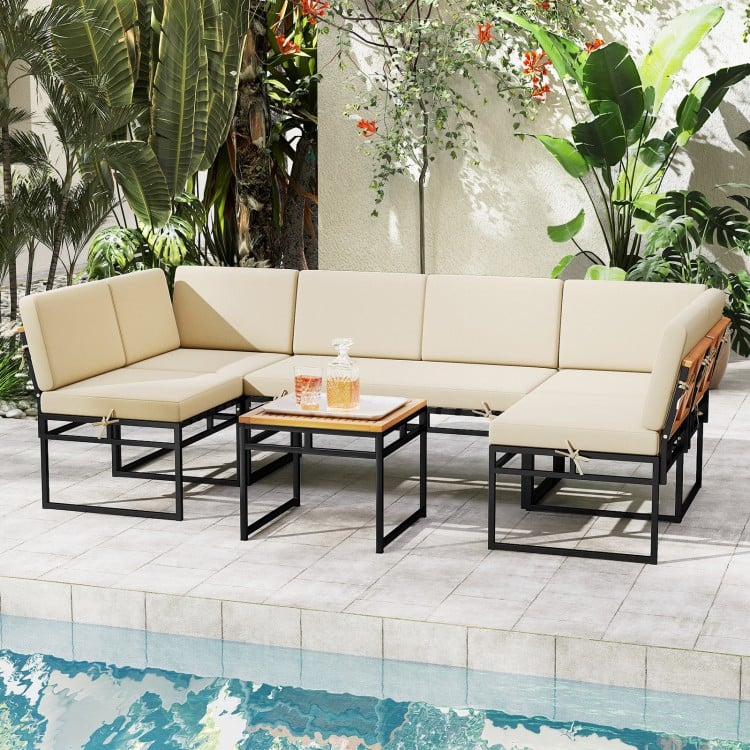 Beige 6-piece outdoor sectional sofa set with metal frame and acacia wood tabletop, ideal for poolside relaxation.