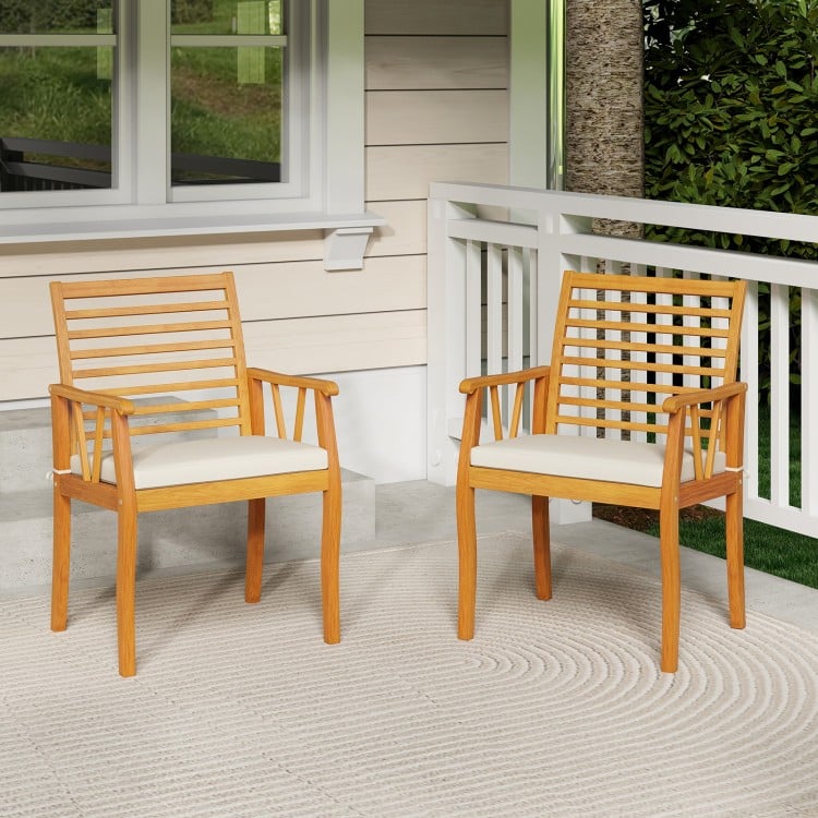 Two acacia wood patio dining chairs with removable cushions, perfect for outdoor bistro conversations on the porch.