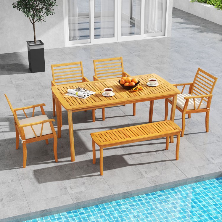 Outdoor acacia wood dining set with two armchairs and removable cushions, perfect for patio meals by the pool.