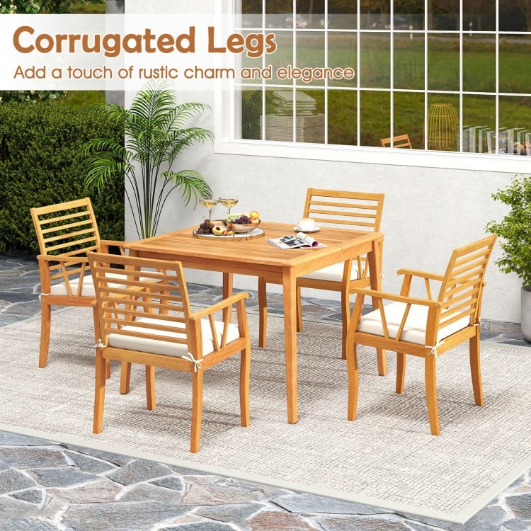 Outdoor acacia wood armchairs with removable cushions and corrugated legs, perfect for bistro dining and conversation.