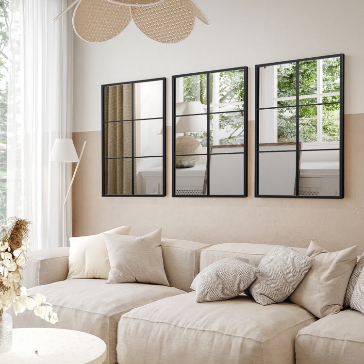 Three-layered decorative wall mirror with a black metal frame, ideal for modern living room decor and space-saving.