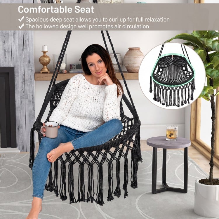 Hanging hammock chair with soft cushions, sturdy rope chain, and elegant tassels, perfect for indoor or outdoor.