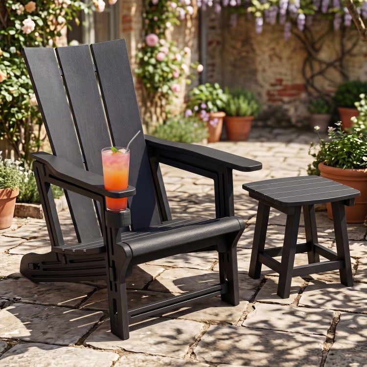 Black HDPE outdoor Adirondack chair with cup holder and wide armrests, perfect for relaxing in your garden or patio.