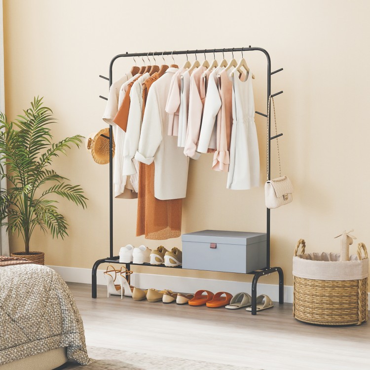 Heavy duty black metal garment rack with hanging rod, side hooks, and bottom shelf for versatile storage in any room.