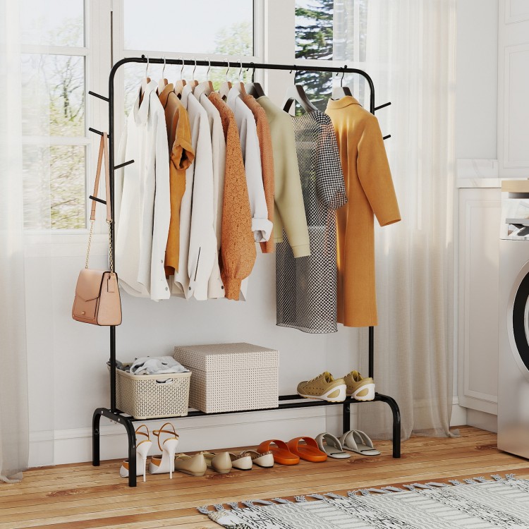 Heavy duty black metal garment rack featuring a stylish design with hanging clothing and shoes on the bottom shelf for.