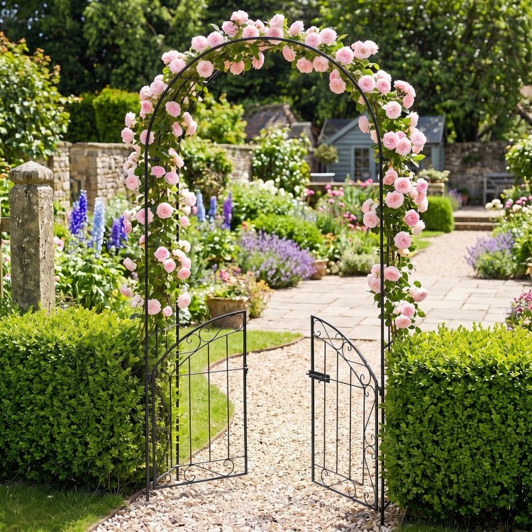 Heavy-duty black metal garden arch with gate, adorned with pink roses, perfect for supporting climbing plants and.
