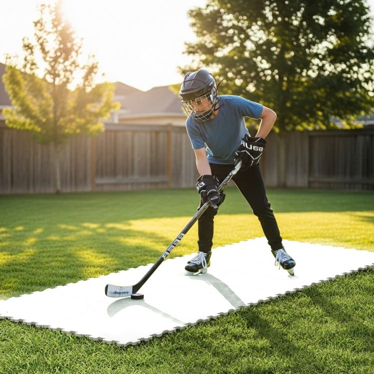 Young player practicing hockey on synthetic ice tiles, featuring premium UHMW-PE material for realistic puck handling.