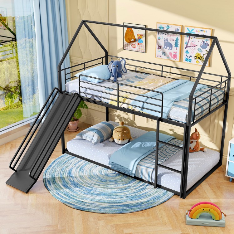 House-shaped black metal twin over twin low bunk bed featuring a slide, spacious lower bunk for play and storage.