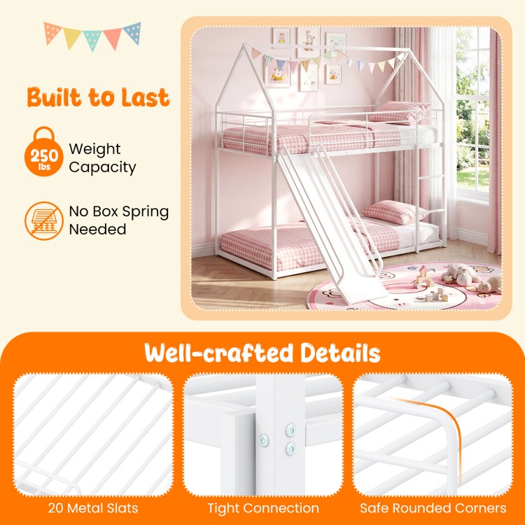 House-shaped metal twin over twin low bunk bed in white with slide, safety guardrails, and 250 lbs weight capacity.