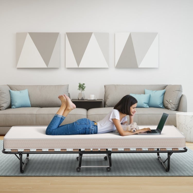 Folding guest bed with memory foam mattress, 75 x 31.5 inches, ideal for living room or office use, shown in a cozy.