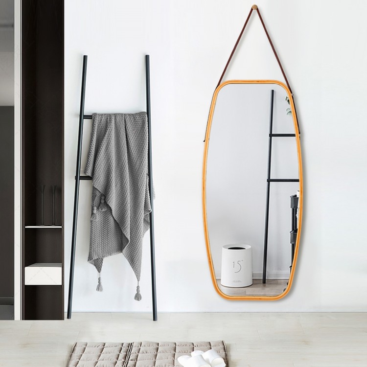 Elegant bamboo-framed wall mirror with adjustable leather strap, ideal for enhancing any space's decor and visual.