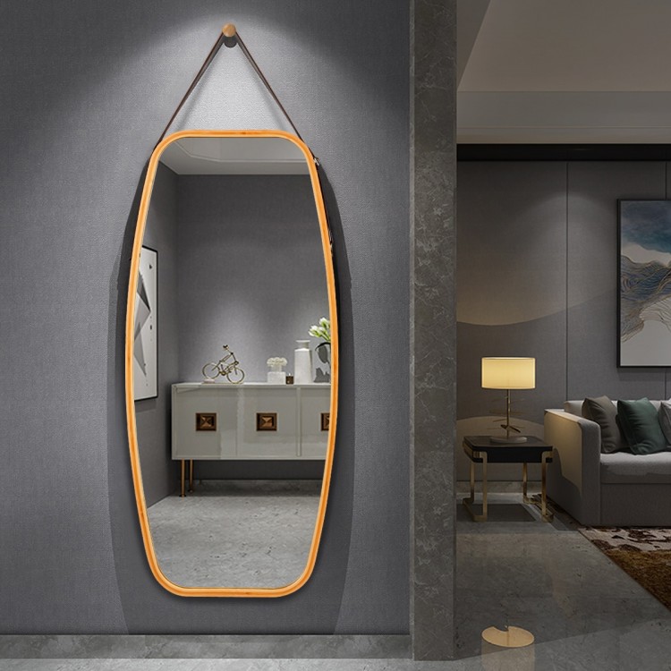 Stylish oval wall mirror featuring a bamboo frame and adjustable leather strap, ideal for enhancing your home’s.