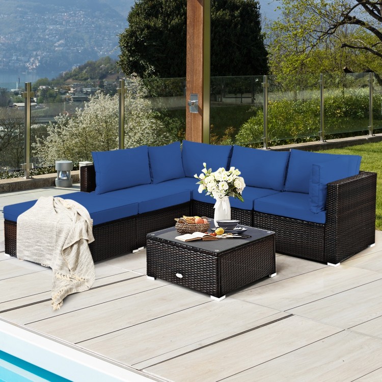 L-shaped outdoor patio rattan sofa set with blue cushions and glass-top coffee table, ideal for garden or poolside.