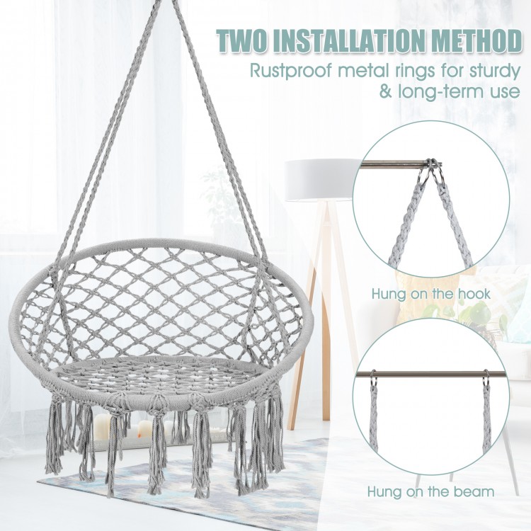 Hanging macrame hammock chair in gray with handwoven cotton backrest, featuring rustproof metal rings for stability.