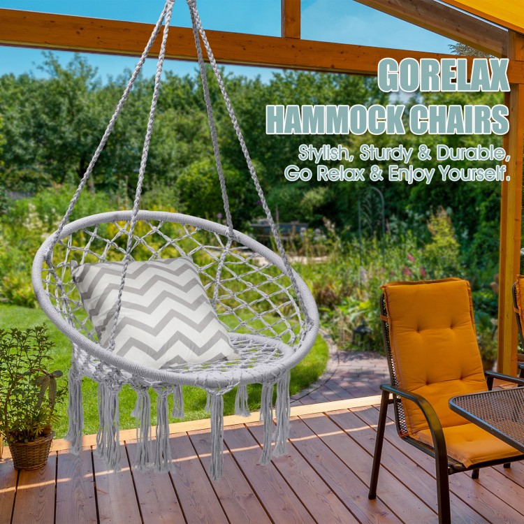 Hanging macrame hammock chair in gray with cotton backrest, ideal for indoor or outdoor relaxation and meditation.