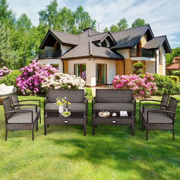 4-piece patio rattan furniture set featuring a loveseat, 2 chairs, and a coffee table, perfect for outdoor relaxation.