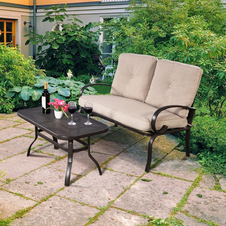 Loveseat with beige cushions and coffee table, made of durable steel, perfect for patio and outdoor relaxation.