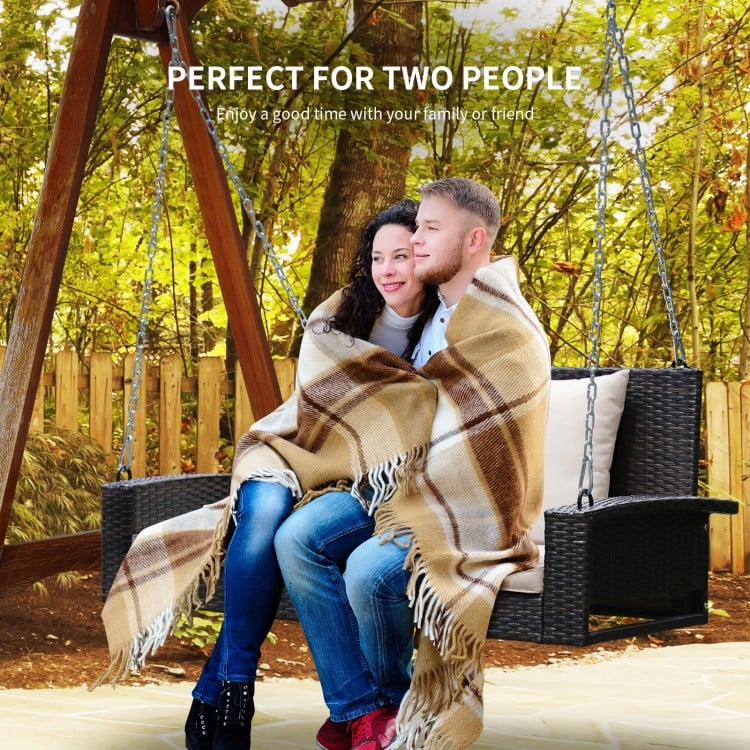 2-person patio rattan swing with cushions, featuring a sturdy design for outdoor relaxation and comfort.