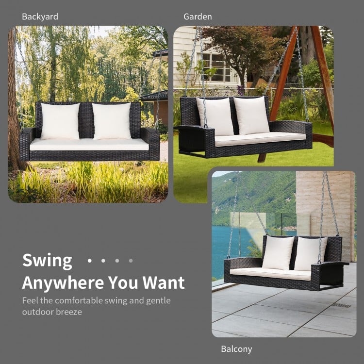 2-person patio rattan swing with white cushions, featuring a sturdy design for outdoor relaxation on porches or.
