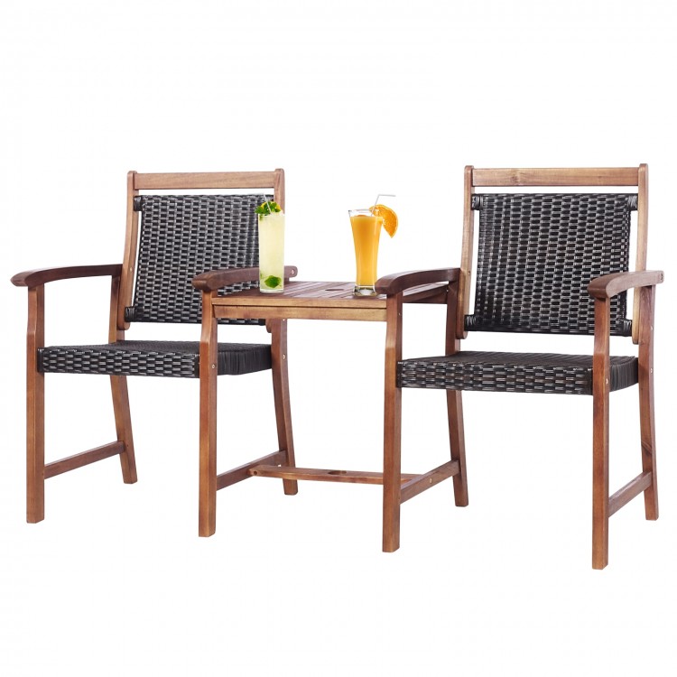 Two acacia wood chairs with rattan seats and a coffee table, perfect for outdoor patio relaxation.