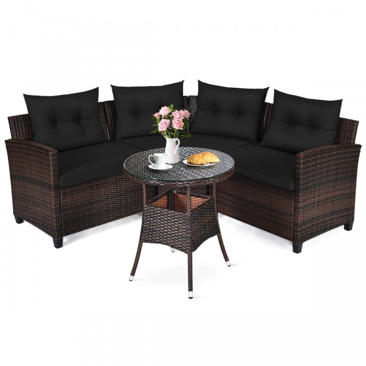 Outdoor cushioned rattan furniture set with black cushions and coffee table, ideal for patio and garden relaxation.