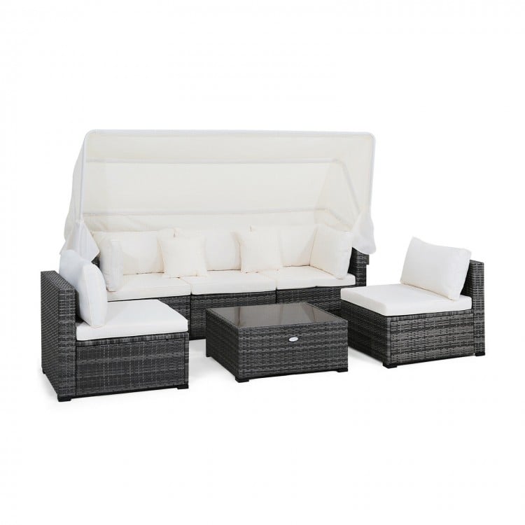 6-piece patio rattan furniture set with retractable canopy, showcasing a side view of the cozy seating arrangement for.