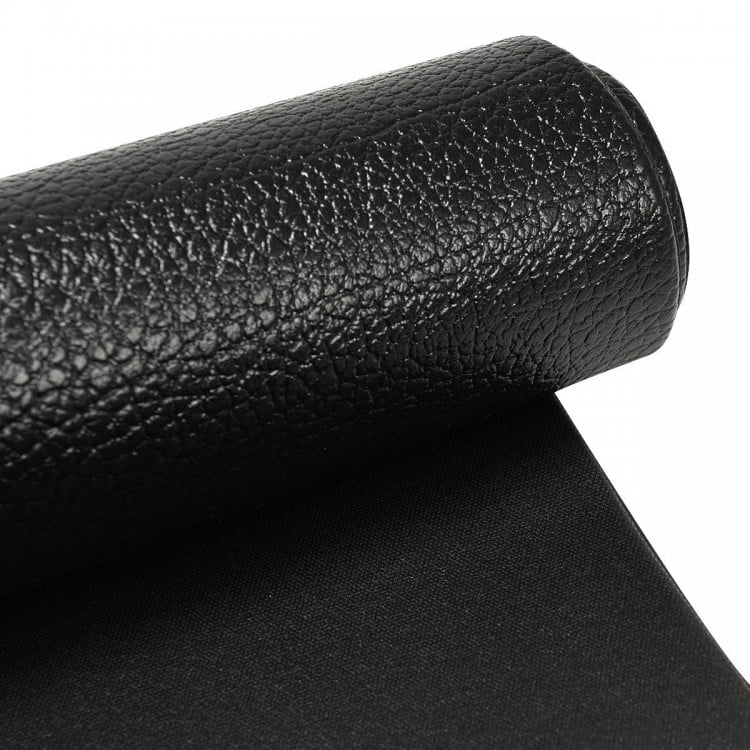 Close-up of a black textured PVC equipment mat, 0.5" thick, designed for home gym use and protecting floors.