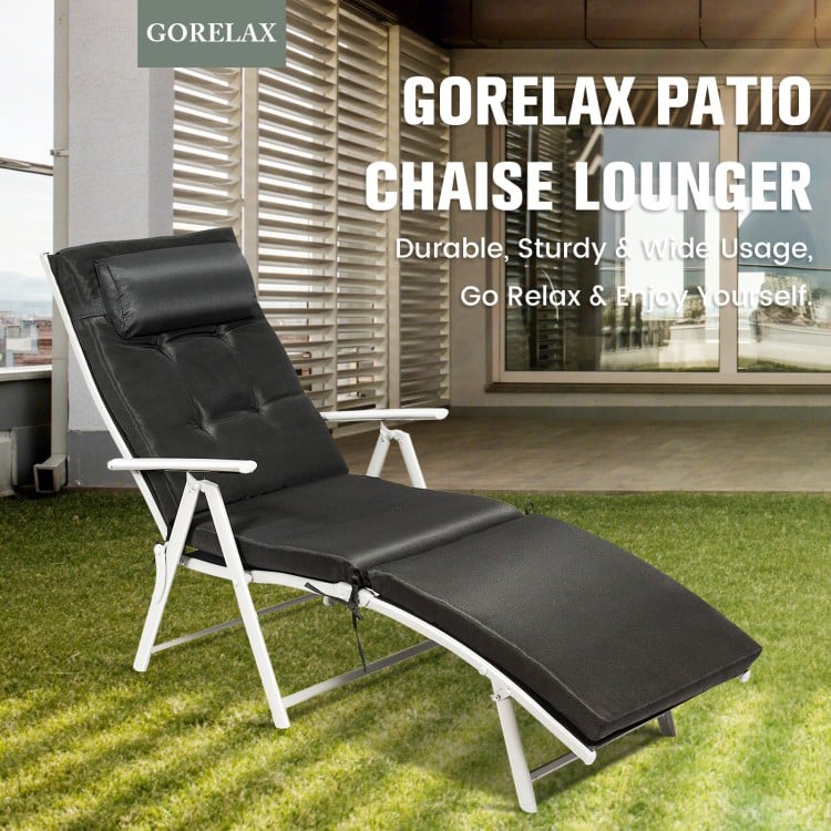 Black adjustable outdoor folding chaise lounge chair with removable pillow, perfect for poolside or backyard relaxation.
