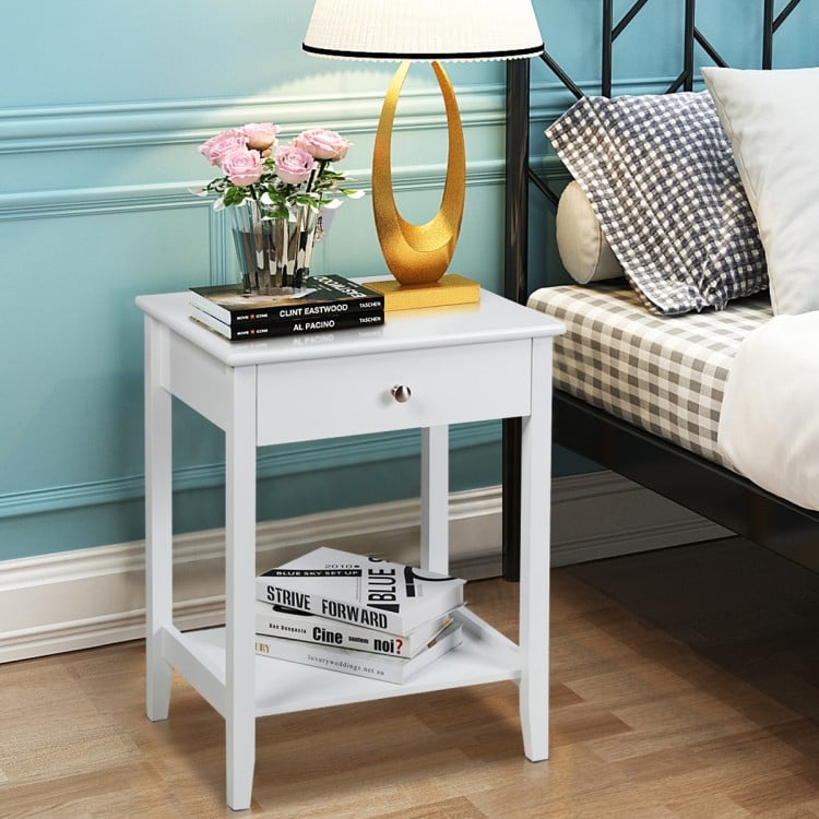 White bedside table with a compact design, featuring a pull-out drawer and bottom shelf, perfect for stylish bedroom.