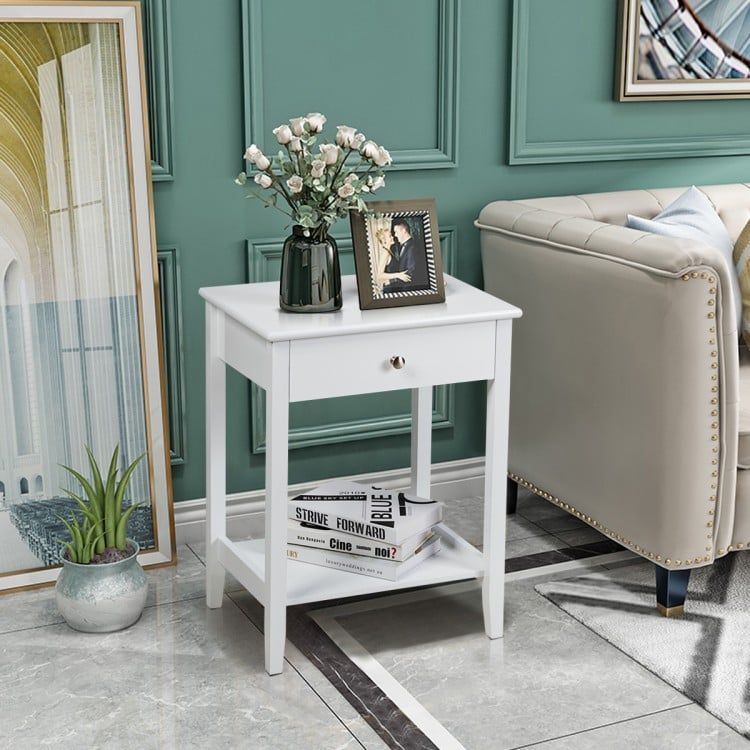 White bedside table with a sleek design, featuring a pull-out drawer and open shelf, perfect for maintaining an.
