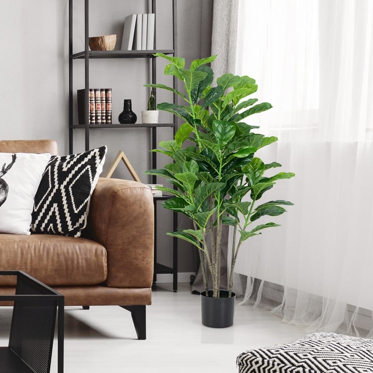 Artificial fiddle leaf fig tree in a stylish living room, featuring lush green leaves and a sturdy pot for indoor decor.