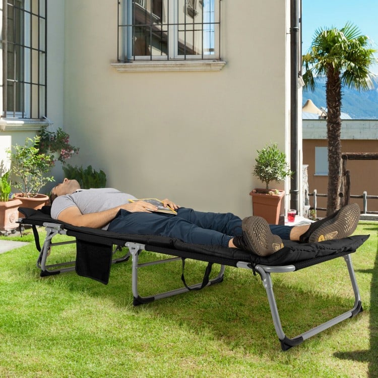 Oversize padded folding lounge chair in black with removable mattress, perfect for outdoor relaxation in the garden.