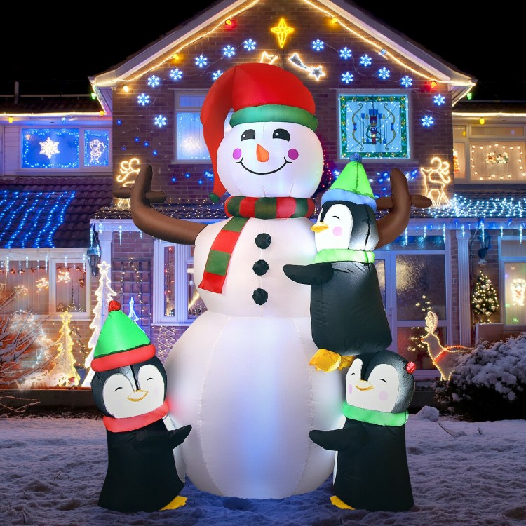 6ft inflatable snowman with 3 penguins, bright LED lights, perfect for festive outdoor Christmas decoration.