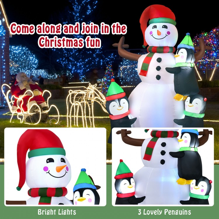 Inflatable snowman with red and green hat, surrounded by cheerful penguins, bright LED lights for captivating holiday.